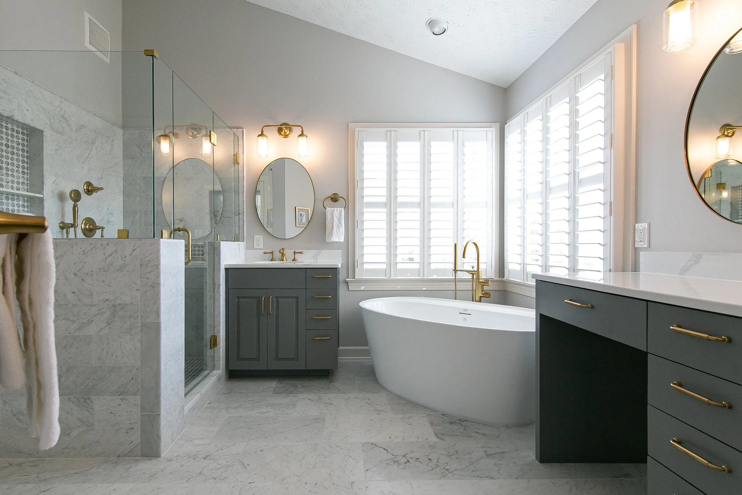 Luxury bathroom remodel with marble and brass finishes