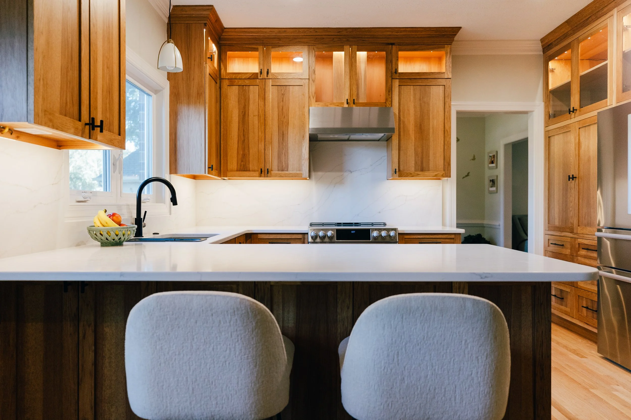 Custom natural wood kitchen with illuminated cabinetry