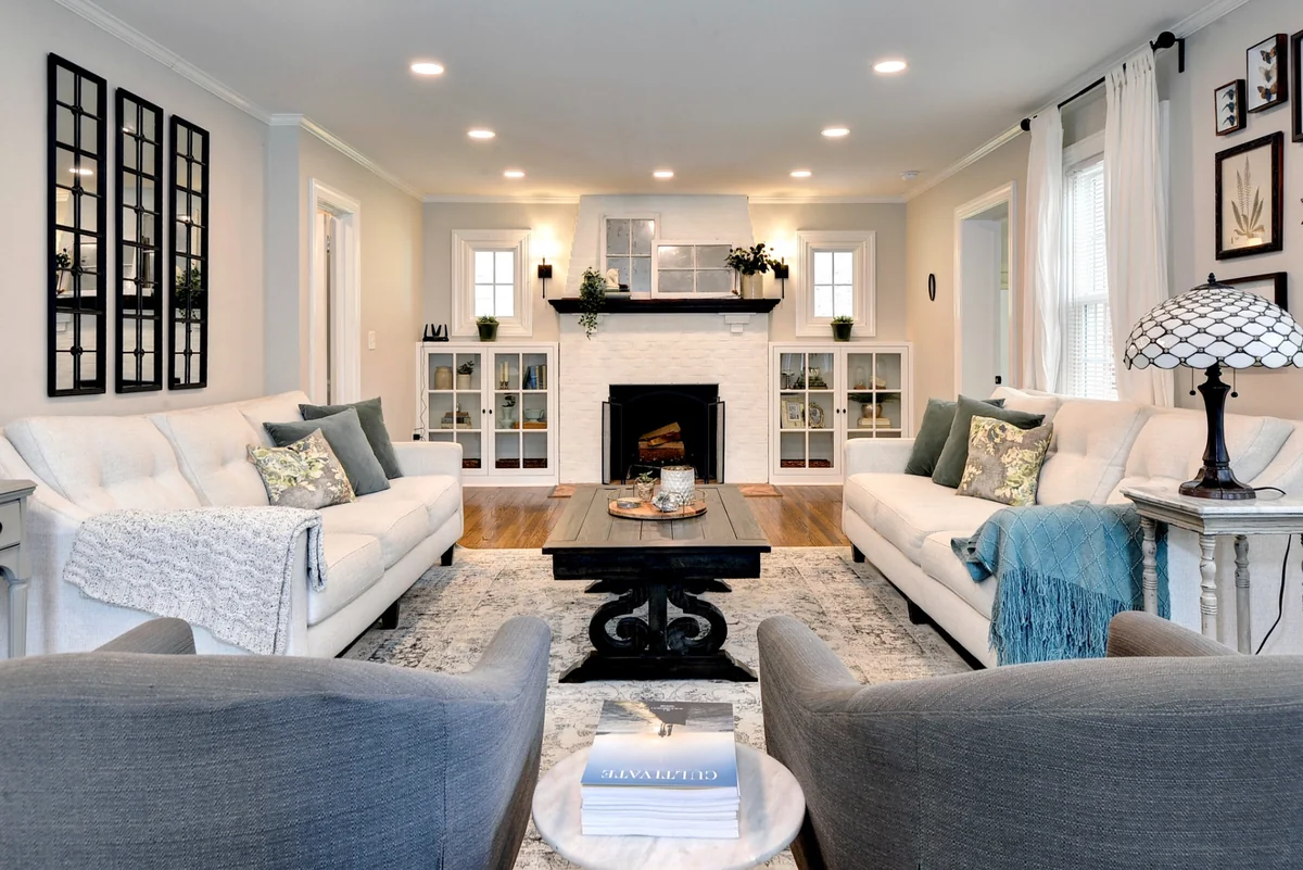 VanFleet Homes living room remodel with a white brick fireplace, built-in cabinets, and hardwood flooring