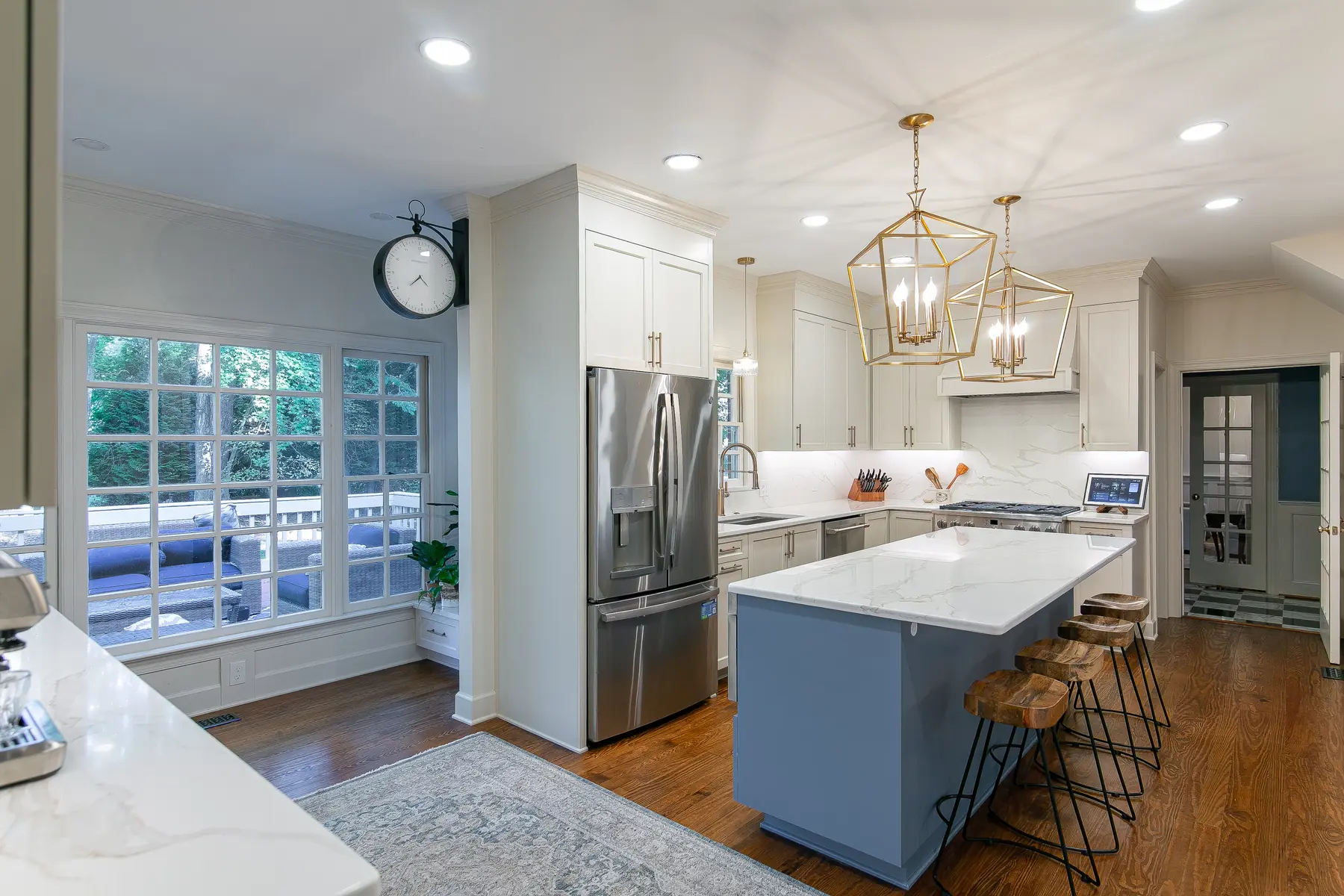 Kitchen work-zone overview with blue island, sink wall, professional range, and coffee station in Kingsmill Williamsburg
